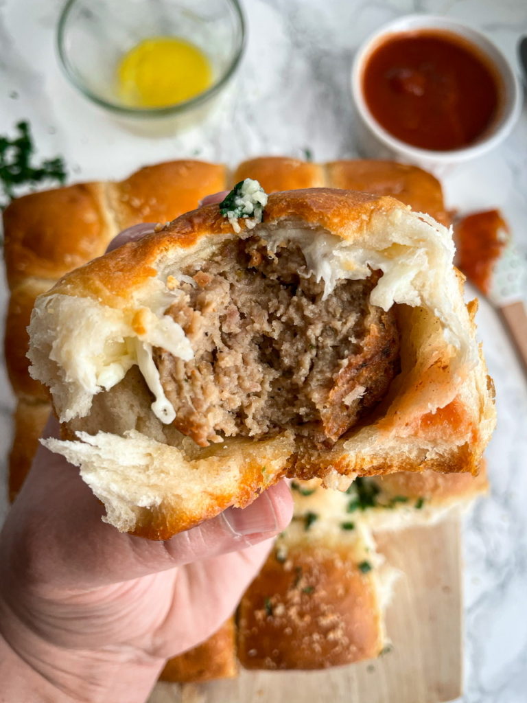 close up of a meatball stuffed biscuit