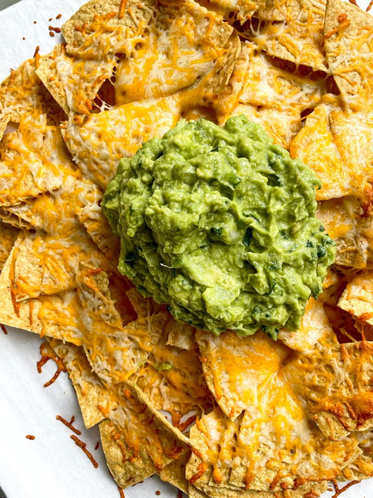The best guacamole on top of cheesy nachos