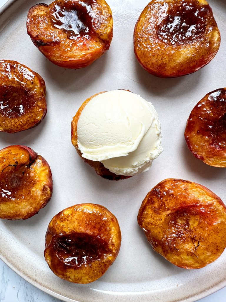 Air Fryer Peaches with Cinnamon Sugar Butter and topped with Vanilla Ice Cream