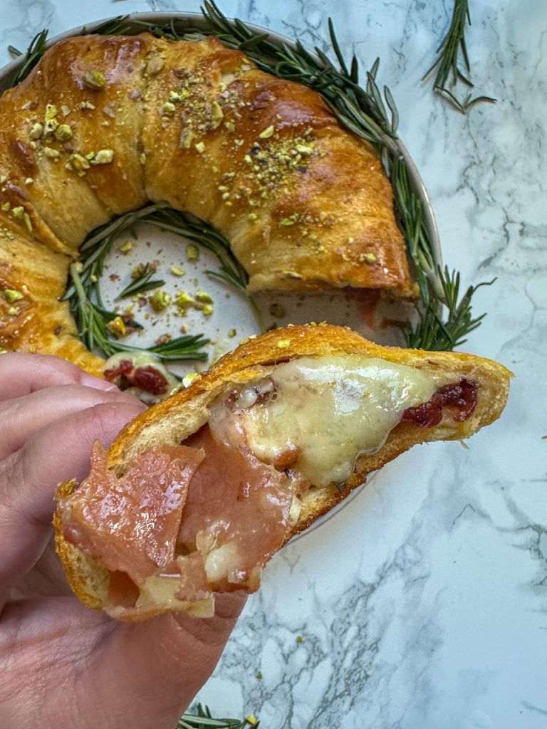 Crescent Roll Wreath stuffed with cranberry sauce, brie, and crispy prosciutto