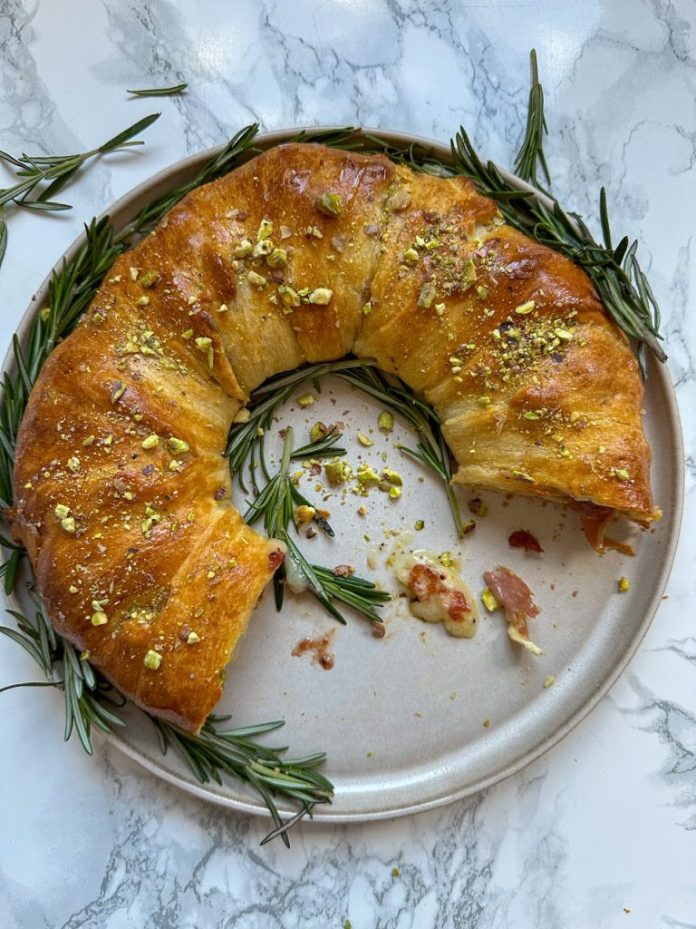 Crescent Roll Wreath with Cranberry, Brie, and Prosciutto topped with Hot Honey and Pistachios
