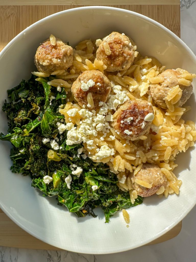 Lemon Chicken Meatballs and Orzo served with garlic Kale and Feta Cheese