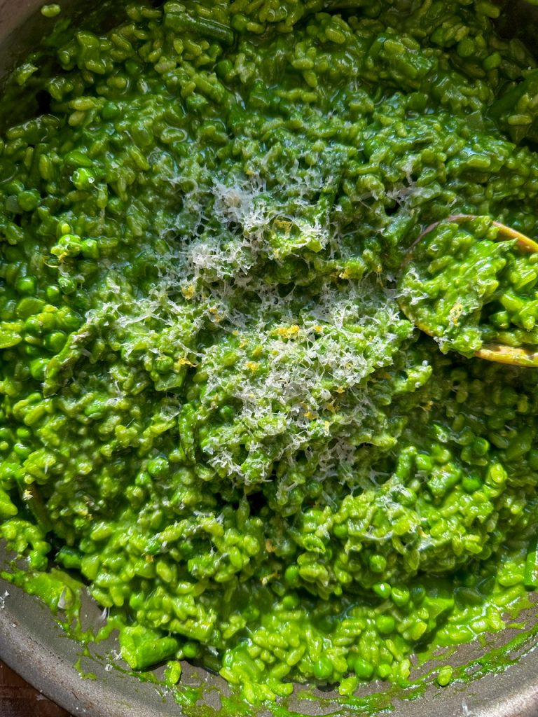 Risotto Verde (Green Risotto) made with spinach, peas, and asparagus. Topped with lemon zest and parmesan cheese
