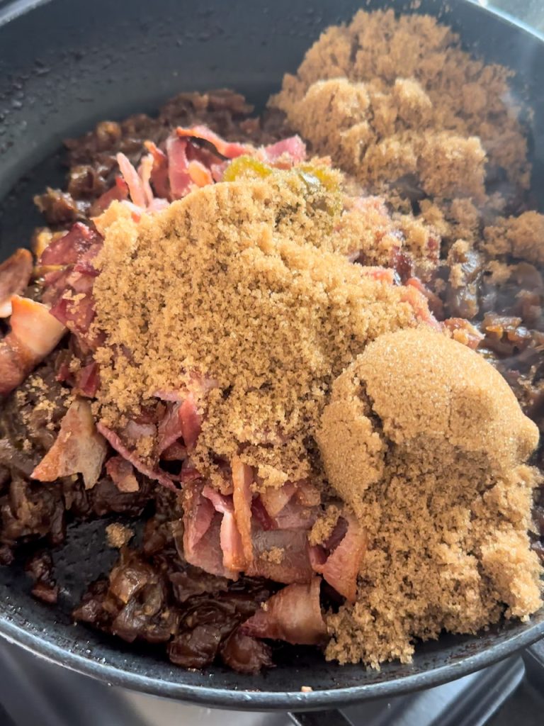 brown sugar being added to bacon jam