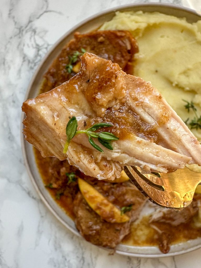 Close-up of slowcooker pork chops and apples