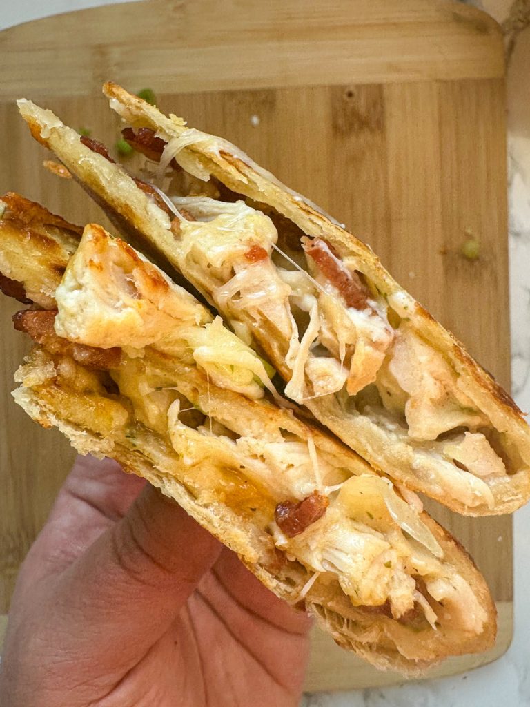 a quesadilla with shredded chicken, crispy bacon, cheese, and ranch dressing