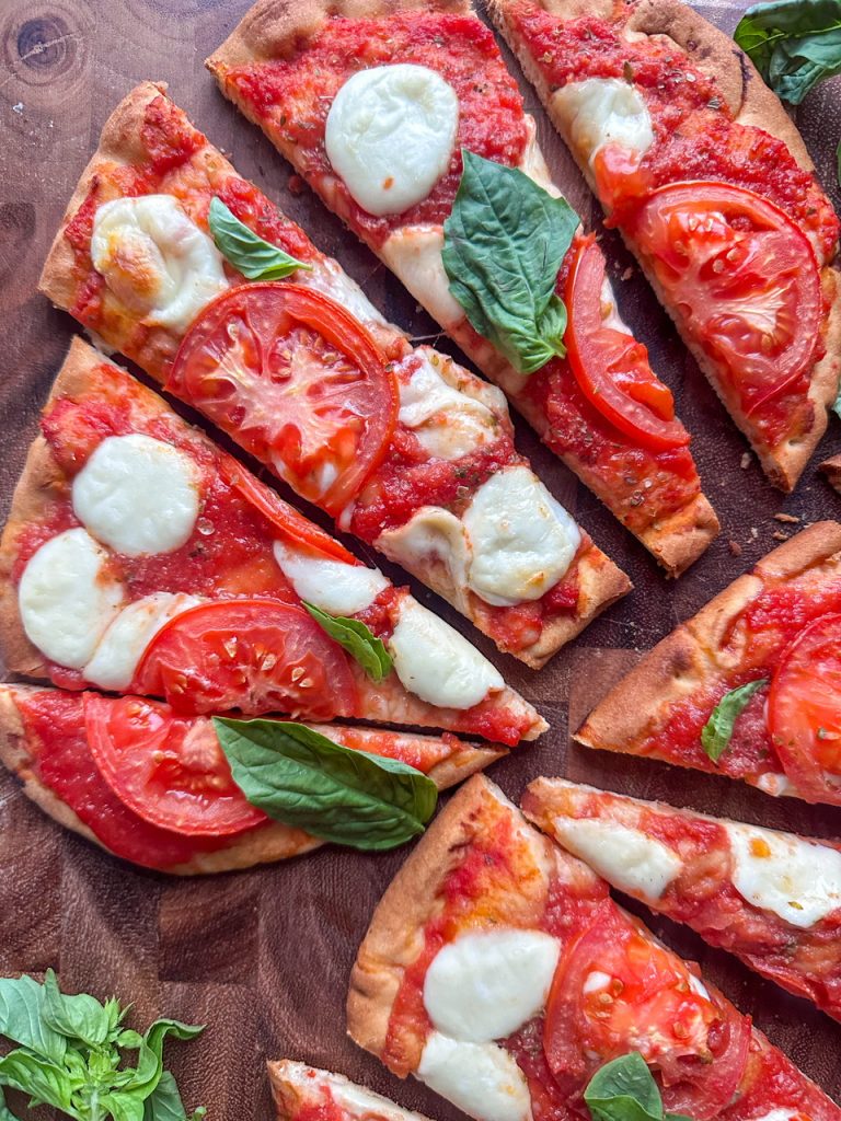 margherita flatbread made on naan with crushed tomatoes, fresh mozzarella, basil, and olive oil.